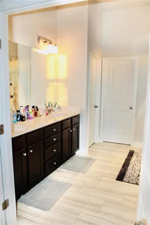 a bathroom with a glass shower door and a bathtub