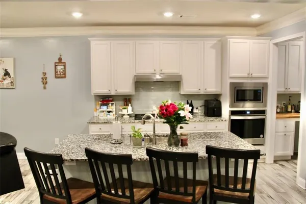a dining room with furniture and kitchen view