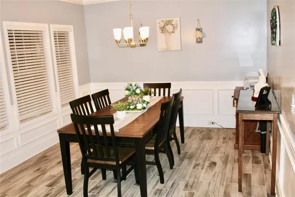 a view of a dining room with furniture and wooden floor