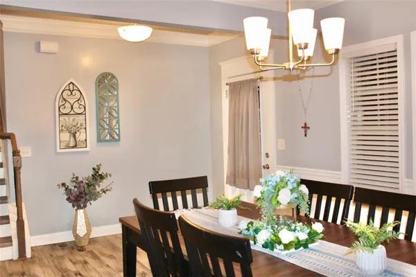a dining room with furniture and wooden floor