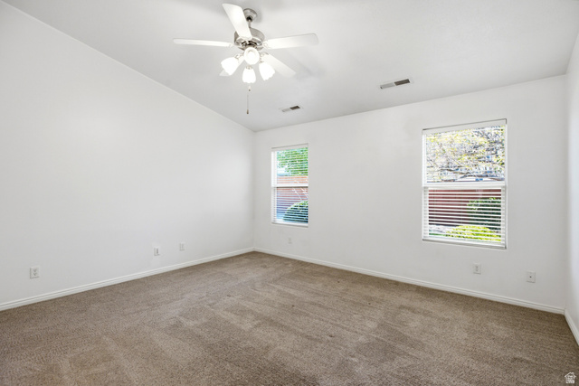 1630 East 2450th Street South, Unit 263 St. George, UT 84790 - Photo 17 of 24 Spacious room featuring neutral carpet flooring, a ceiling fan with integrated lighting, and two windows with horizontal blinds
