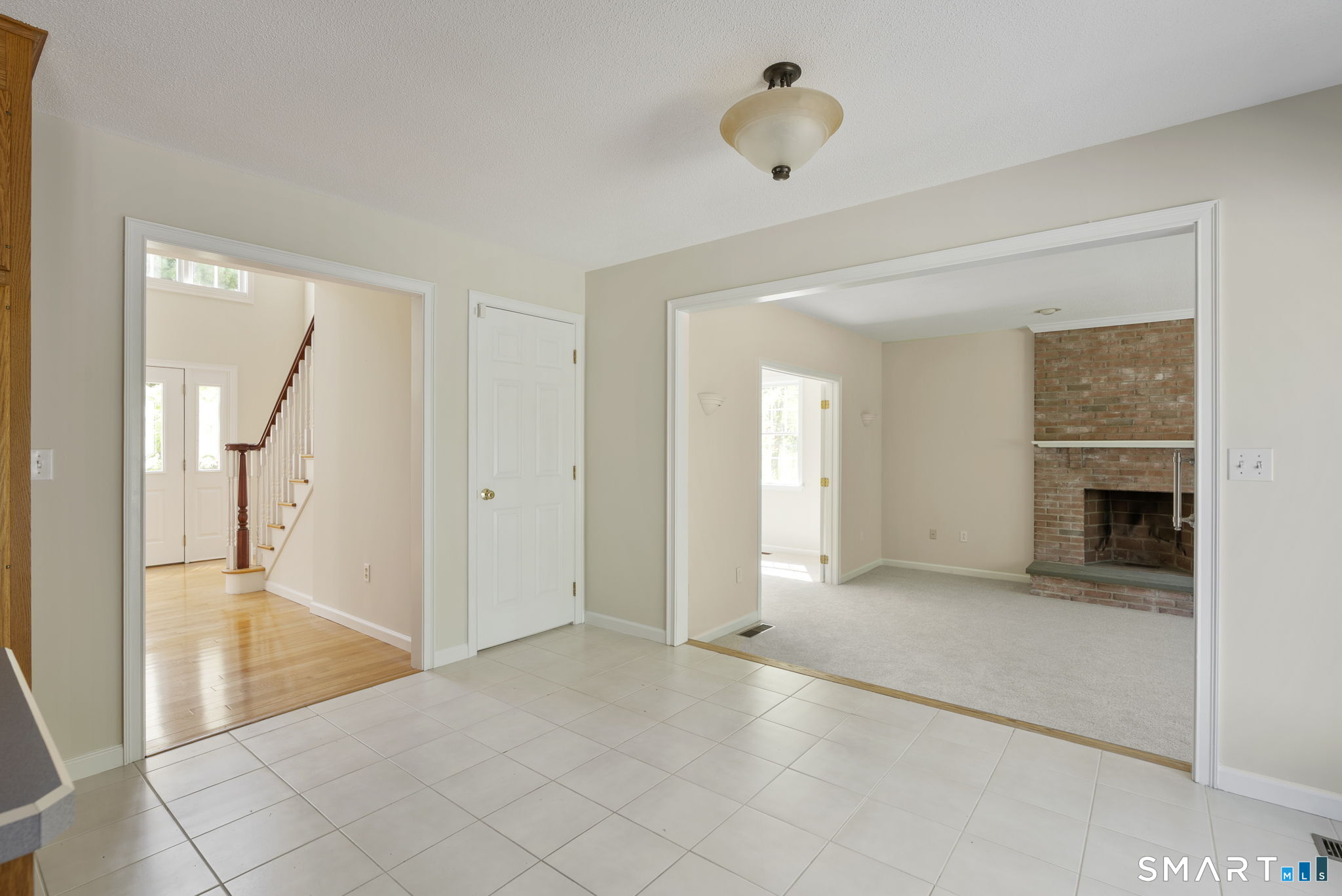 555 Waterville Road Avon, CT 06001 - Photo 22 of 40 a view of an empty room with a fireplace and a window