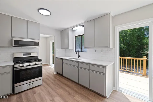a kitchen with a refrigerator stove and wooden cabinets