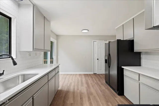 a view of a hallway with wooden floor and entryway