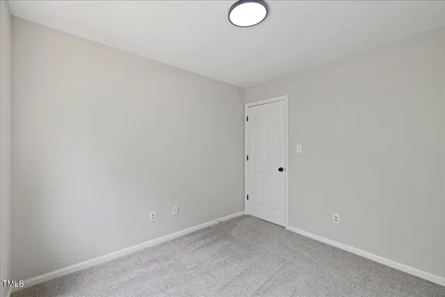 a spacious bedroom with a bed and a window