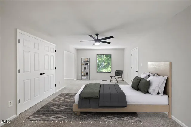 a view of a livingroom with a ceiling fan and window