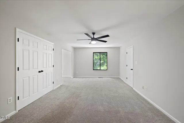 a view of an empty room with a window
