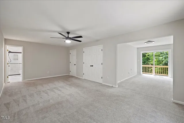 a view of an empty room with a ceiling fan