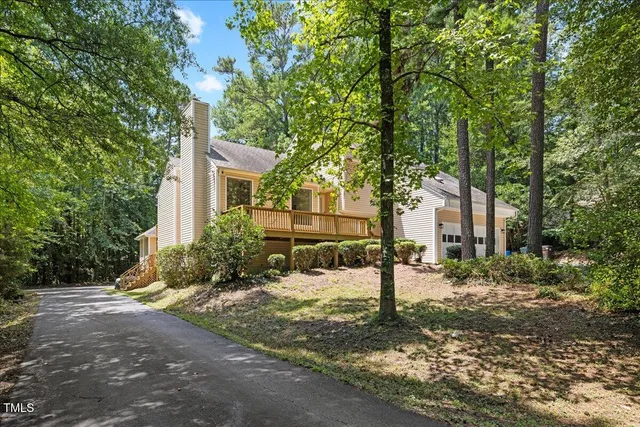 a view of a house with a tree in the background