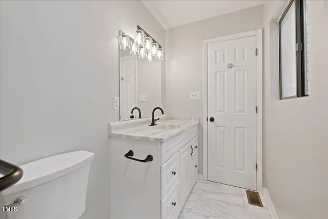 a bedroom with furniture and a window