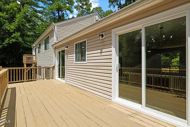 a view of a house with backyard and a tree