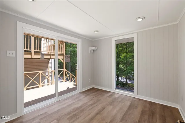 a view of a house with backyard and a tree