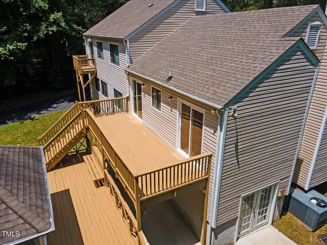 a front view of a house with a garden and trees