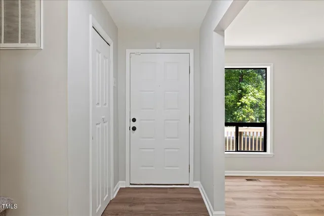 a view of a hallway with windows and entryway