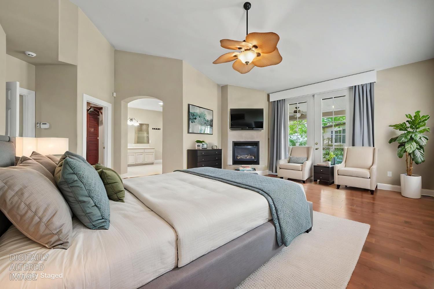 532 Oakridge Road Valley Springs, CA 95252 - Photo 48 of 89 a spacious bedroom with a large bed and a chandelier
