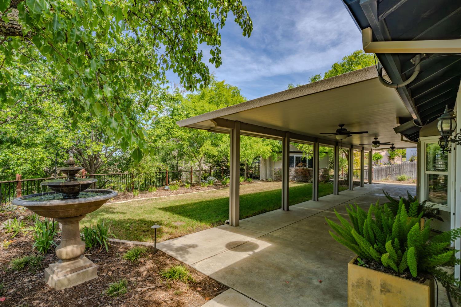 532 Oakridge Road Valley Springs, CA 95252 - Photo 66 of 89 a view of a backyard with table and chairs under an umbrella