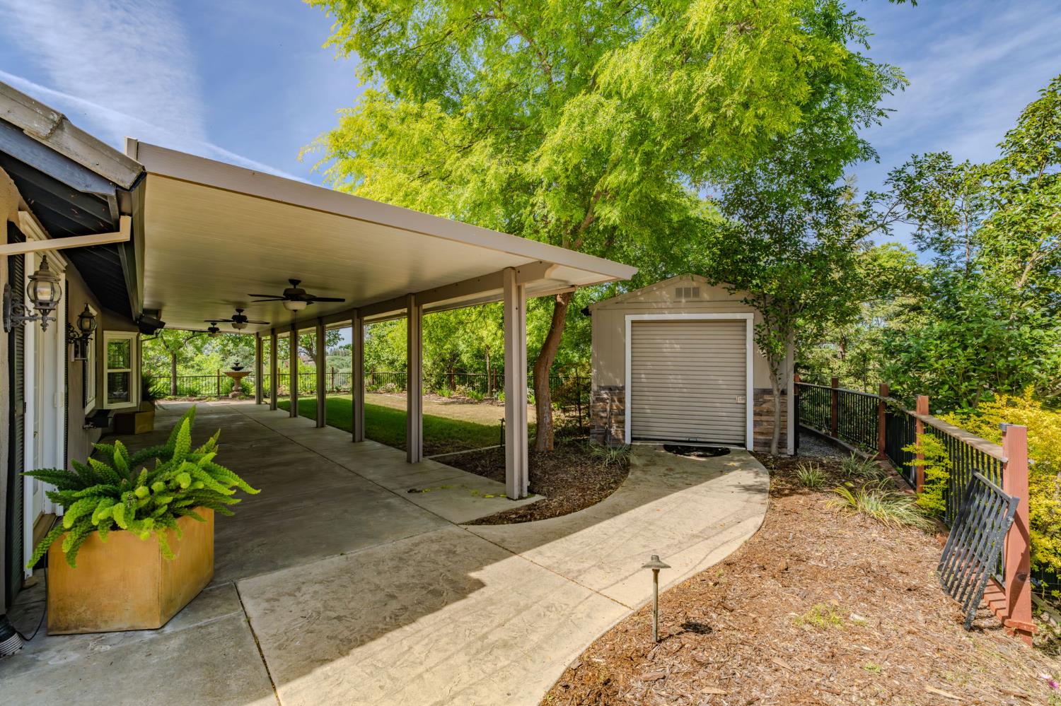 532 Oakridge Road Valley Springs, CA 95252 - Photo 75 of 89 a view of a patio with a table and chairs under an umbrella