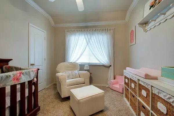 a room with furniture a baby crib and a couch