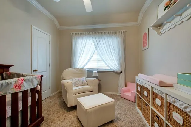 a room with furniture a baby crib and a couch