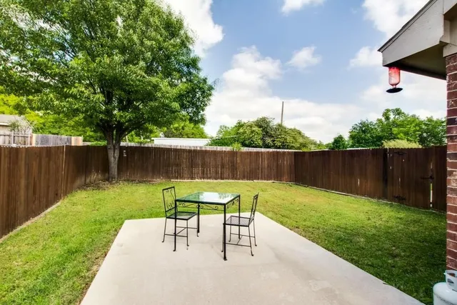 a view of a backyard with sitting area