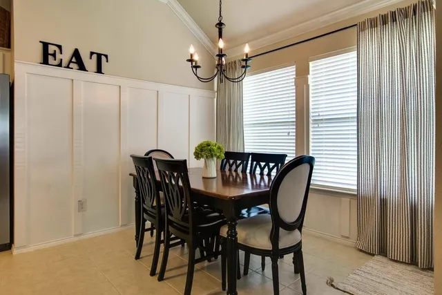 a view of a dining room with furniture and a chandelier