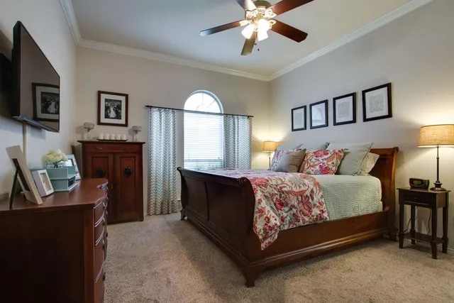 a spacious bedroom with a bed and a chandelier