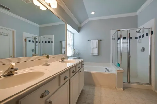 a bathroom with a granite countertop sink a mirror a bathtub and shower