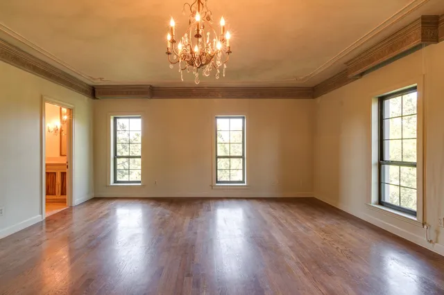 a view of wooden floor and windows in a room