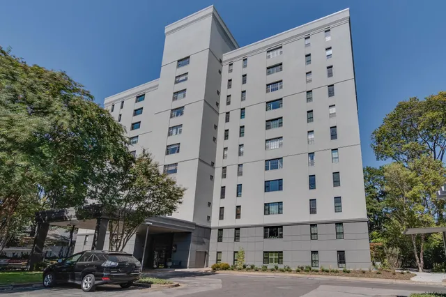 a view of a room with lots of wooden furniture and windows
