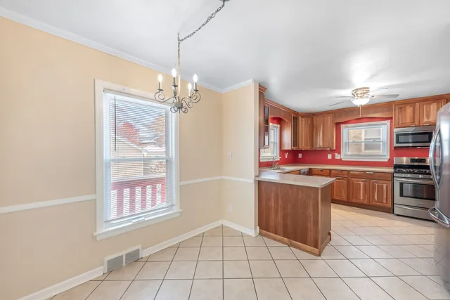 a kitchen with stainless steel appliances granite countertop a refrigerator and a stove top oven