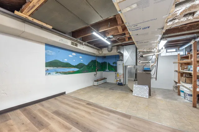 a view of water heater room with stairs