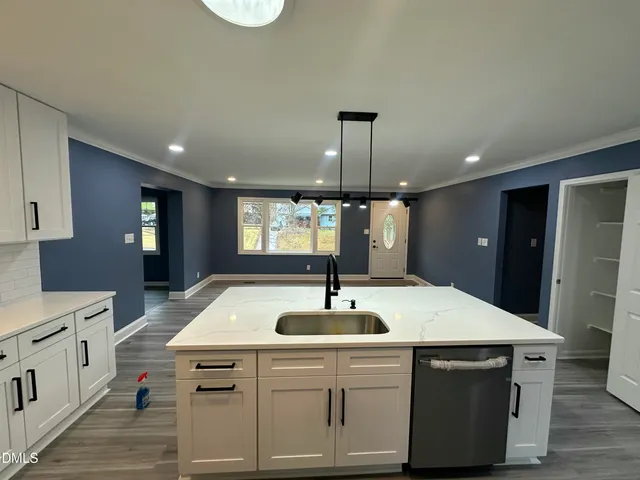 a kitchen with stainless steel appliances a sink and a refrigerator