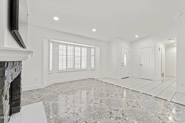 a view of an empty room with a fireplace