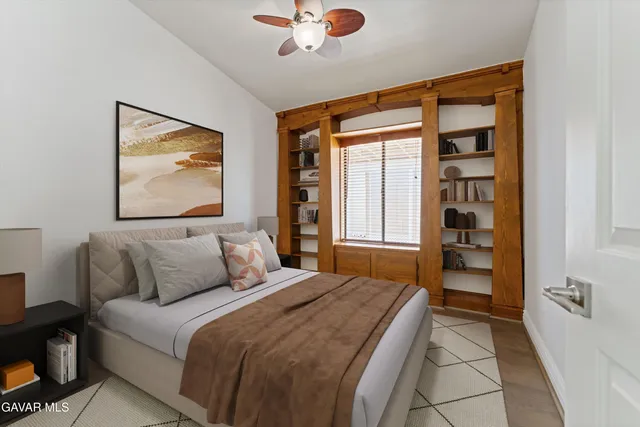 a bedroom with a large bed and a window