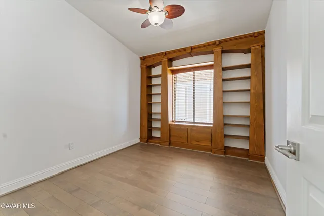 an empty room with windows and closet