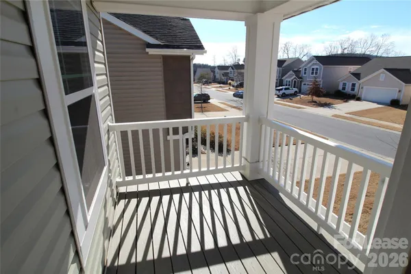 a view of a balcony with wooden floor