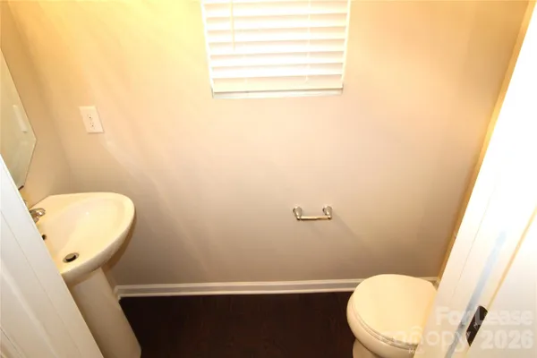 a toilet sitting in a bathroom next to a sink