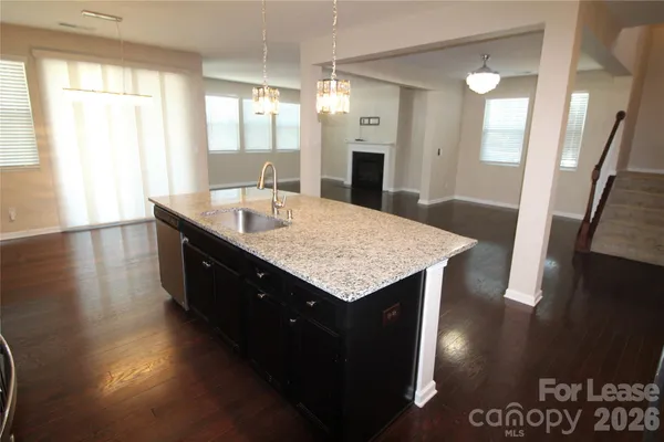 a bath room with a sink a large mirror and vanity