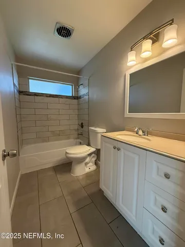 a bathroom with a double vanity sink toilet and shower