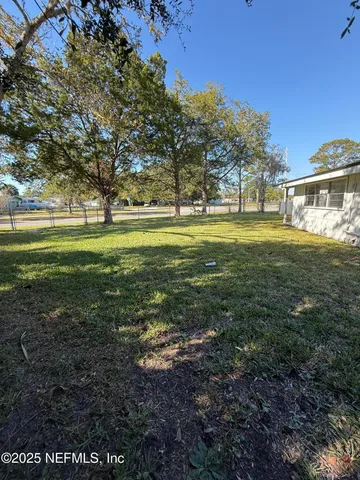 a view of a field with an trees