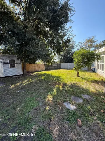 a view of a backyard with large trees