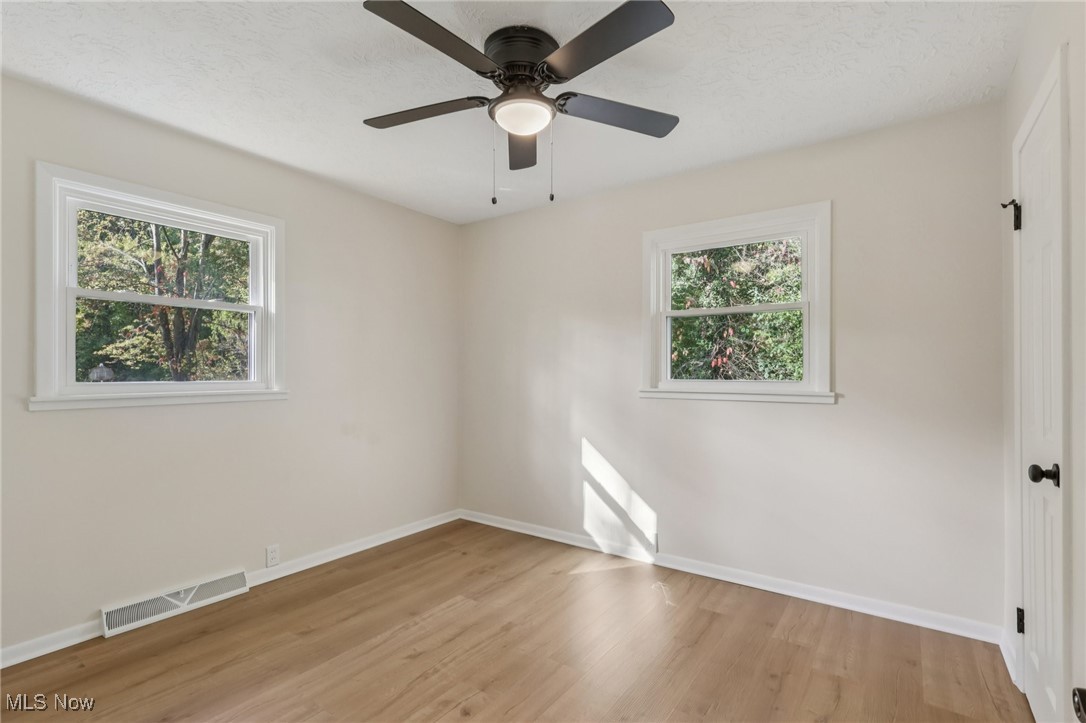 50963 Becker Road Oberlin, OH 44074 - Photo 16 of 37 Spare room with light wood-style floors and ceiling fan