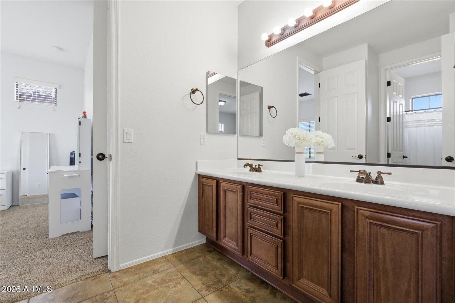 7253 East Nathan Street Mesa, AZ 85207 - Photo 18 of 34 a bathroom with a granite countertop sink and a mirror