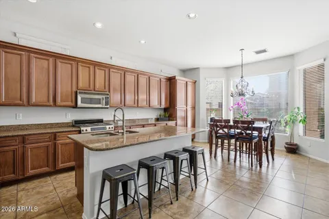 a kitchen with stainless steel appliances granite countertop cabinets and a stove top oven