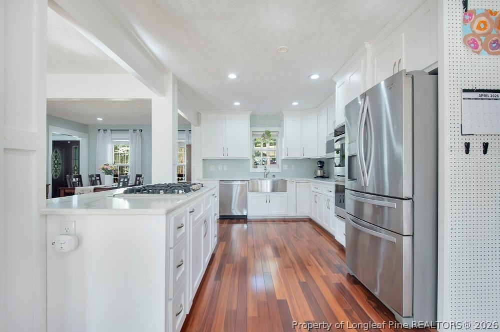 419 Senter Lane Bunnlevel, NC 28323 - Photo 13 of 49 a kitchen with white cabinets and stainless steel appliances