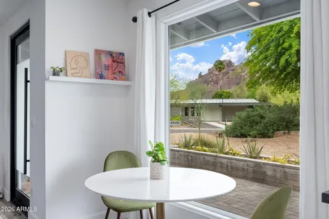a view of a dining room with a table and chairs