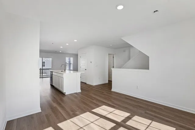 a view of kitchen and hall with wooden floor