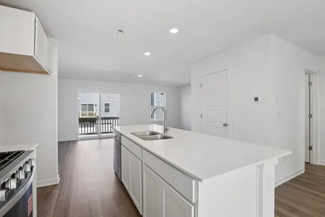 a kitchen with a sink stove and cabinets