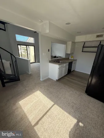 a kitchen with a sink and a stove top oven