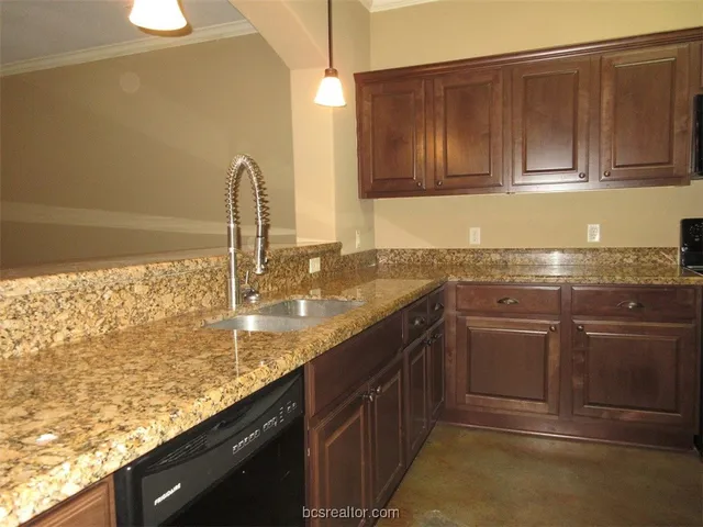 a kitchen with a sink stove and refrigerator